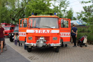 Na zdjęciu widoczny jest stary wóz strażacki z pompą wodną zamontowaną na masce pojazdu