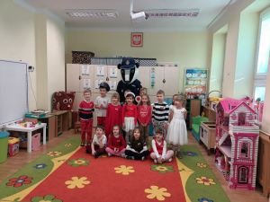 Na zdjęciu sierżant borsuk i przedszkolaki ubrane w biało czerwone stroje.