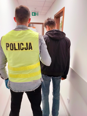 policjant z zatrzymanym mężczyzną